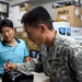 U.S. Army Soldier Purchases Microphone at Seoul Electronics Market
