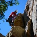 Army Veteran Scales Cliff at USO Rock-Climbing Camp
