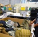 Postal Worker Examines Lost Military Equipment for Return to Defense Department