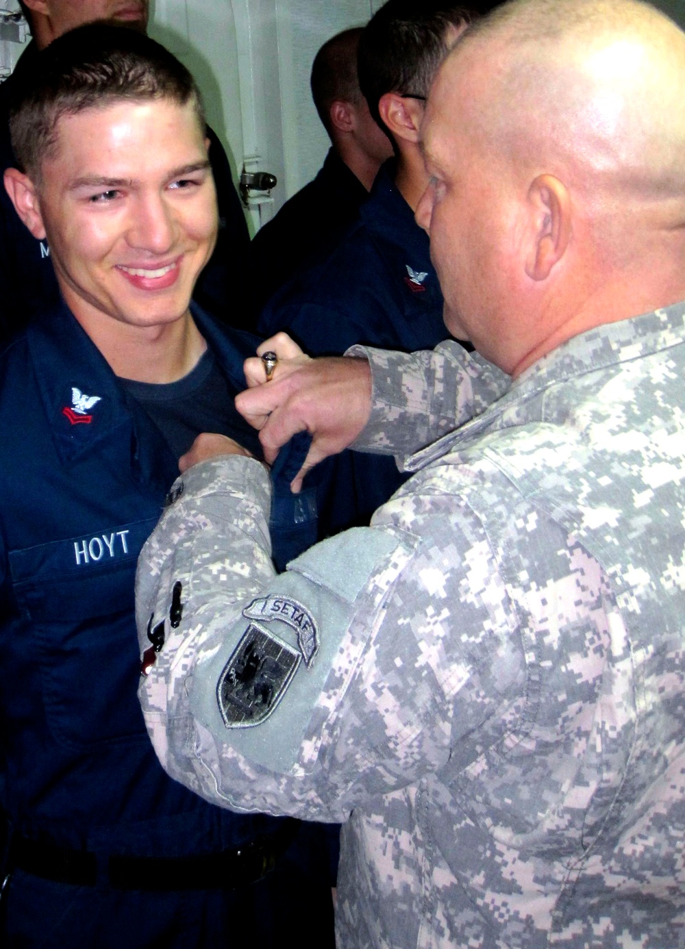 Army Officer Pins Navy Son with Surface Warfare Badge After Family Cruise