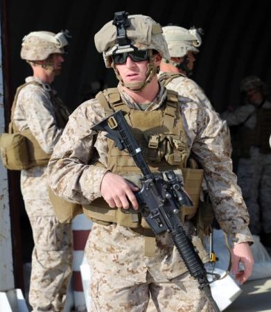 Marine Sergeant Prepares to Load Passengers and Gear onto Hercules Aircraft in Romania