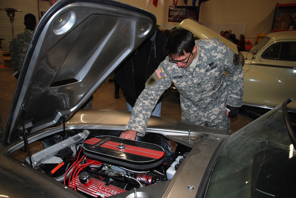 Army Sergeant Inspects Classic Car at Automotivation Program Launch