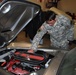 Army Sergeant Inspects Classic Car at Automotivation Program Launch