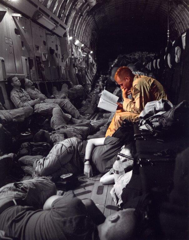 Service Member Reads During Long Military Flight