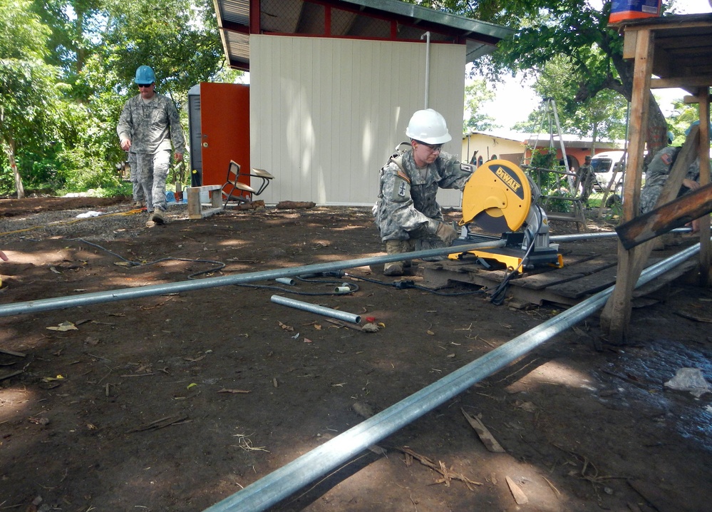 U.S. Soldier Welds Fence Posts for Salvadoran School During Humanitarian Mission