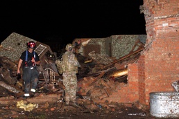 Guardsman and Firefighter Search Tornado Rubble for Survivors in Moore, Oklahoma