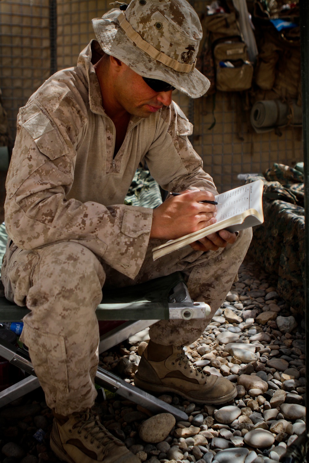Marine Reads Pashtu-English Dictionary in Afghanistan