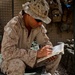 Marine Reads Pashtu-English Dictionary in Afghanistan
