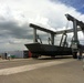 Massive Crane Prepares Boats for Tropical Storm Isaac at Guantanamo Bay