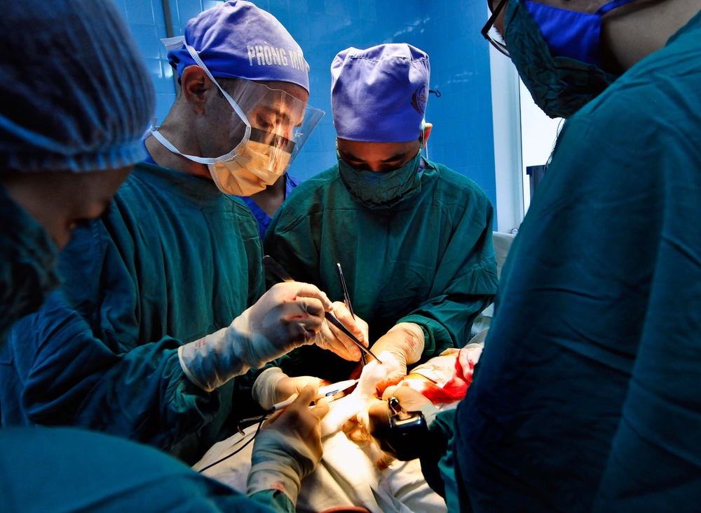 U.S. Navy Officer and Vietnamese Doctors Perform Surgery at Friendship Hospital in Vietnam