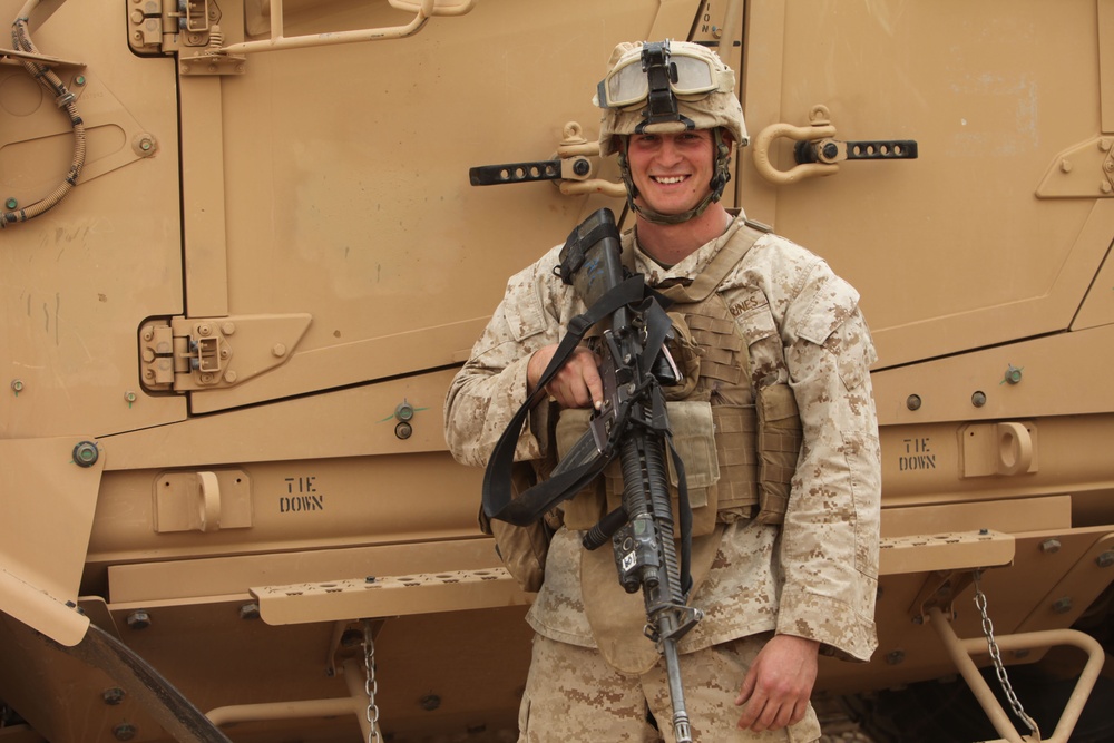 Marine Stands Beside Vehicle at Afghan Camp