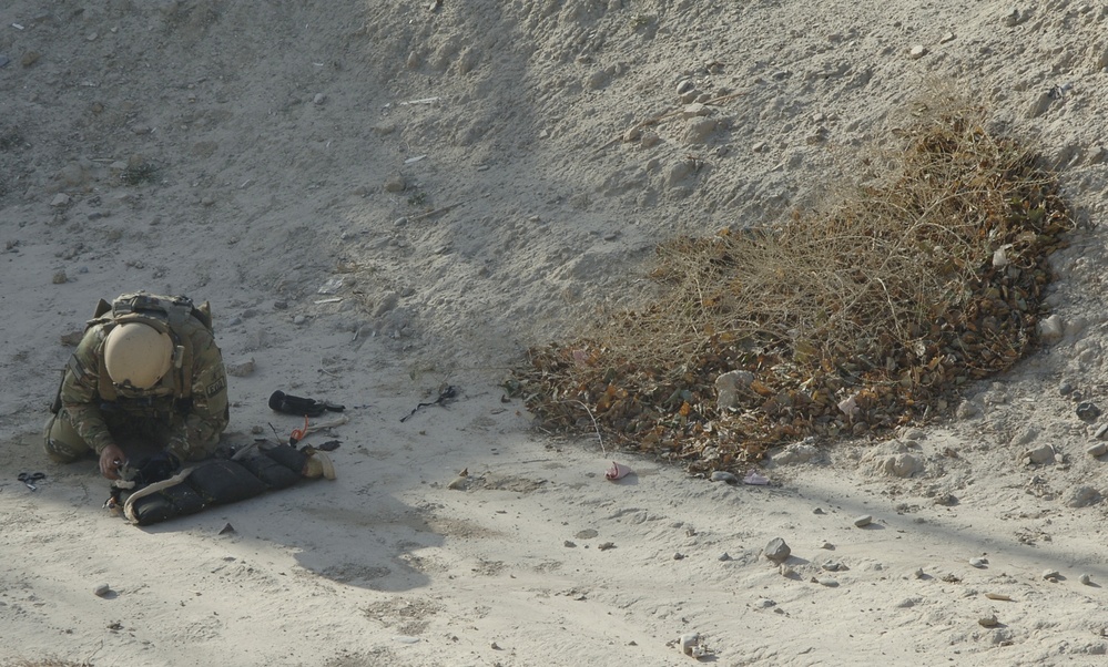 Navy Explosive Ordnance Disposal Technician Inspects Device in Afghanistan