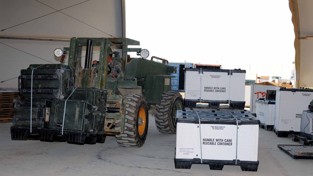 Forklift Loads Pallet of Equipment for Shipment at Iraqi Base