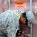 Army Sgt. Seals Container After Customs Inspection in Iraq