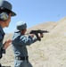 Afghan Police Instructor Guides Trainee on Rifle Range