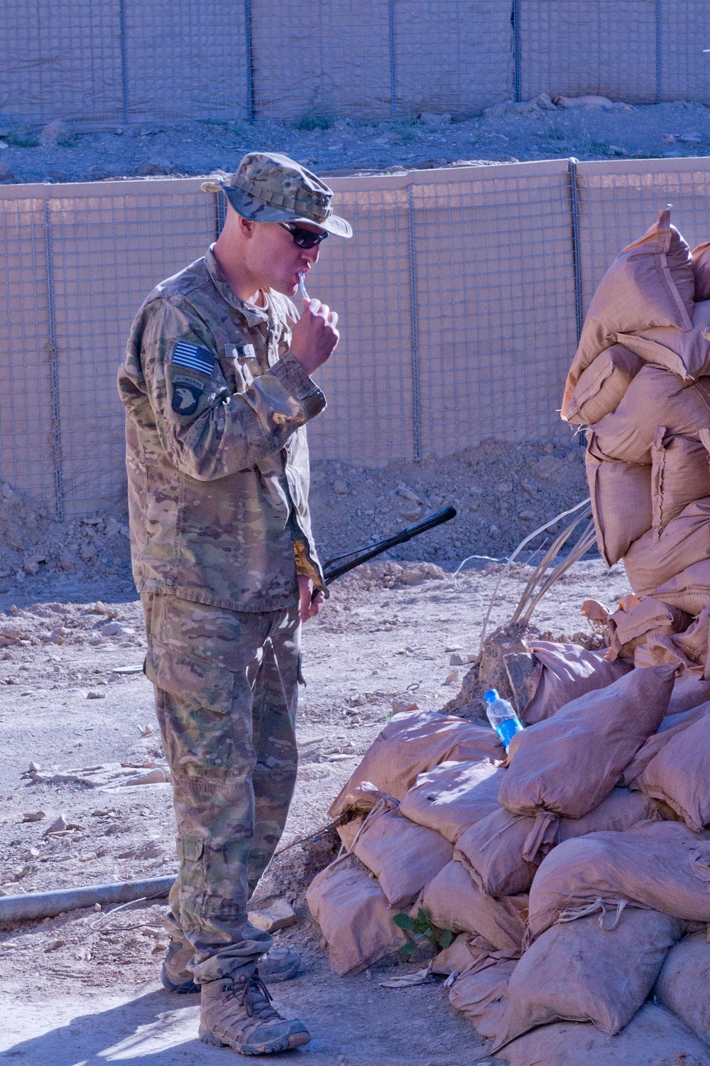 Soldier Brushes Teeth With Bottled Water at Remote Afghan Outpost