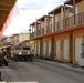 Convoy Navigates Mock Alleyway in Realistic Urban Training Exercise