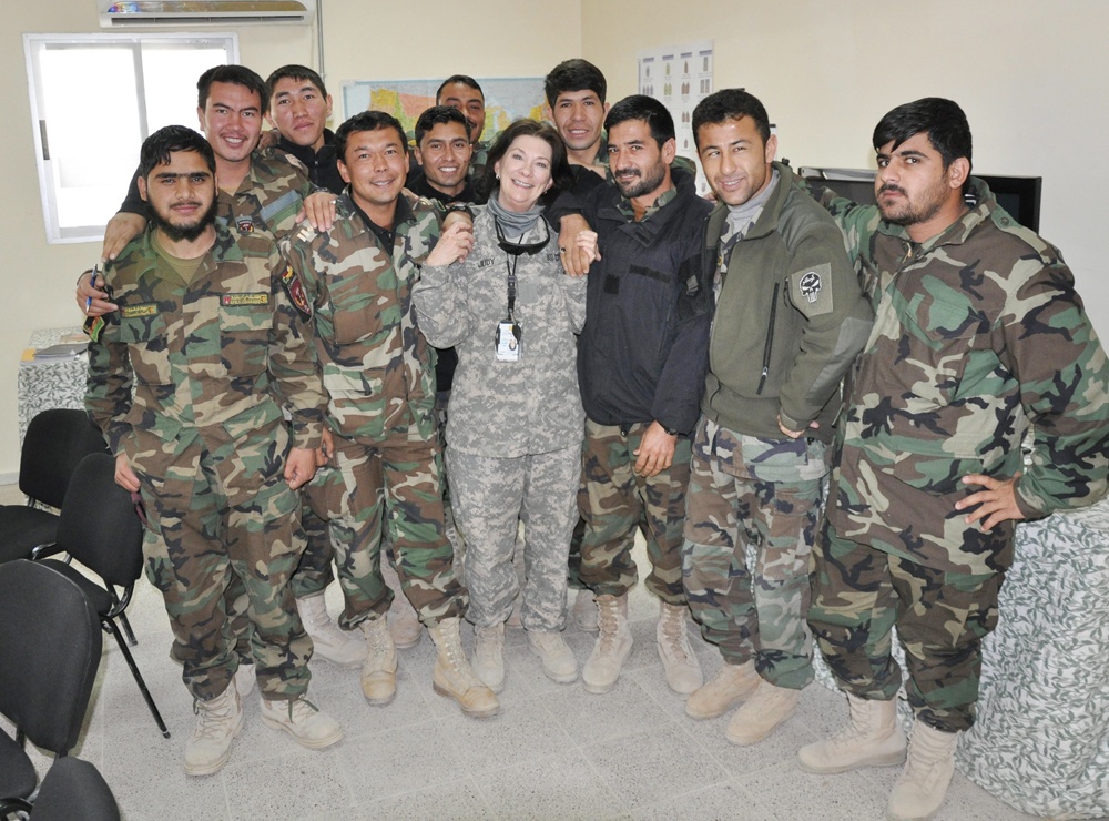 Teacher Judy Ryan Poses with Afghan Students at Remote Base