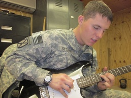 Soldier Serenades Comrades at Afghan Outpost