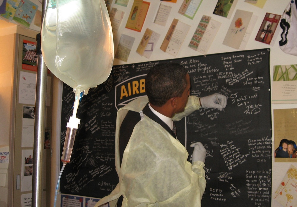 Obama Signs 101st Airborne Flag for Wounded Soldier at Walter Reed