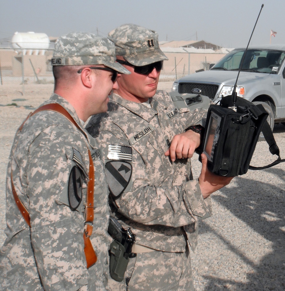 National Guard Officer Discusses Spectrum Analyzer Measurements with Convoy Escort Team in Iraq