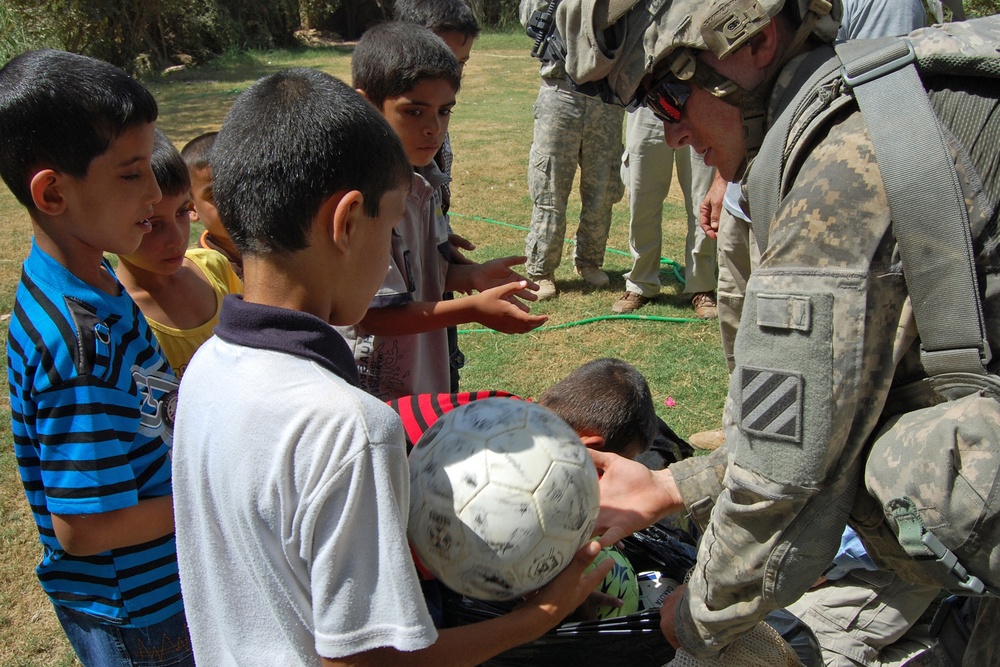 U.S. Soldier Distributes Soccer Balls to Iraqi Children