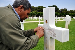 Tunisian Stone Mason Refreshes Gold Leaf on American Soldier's Gravestone