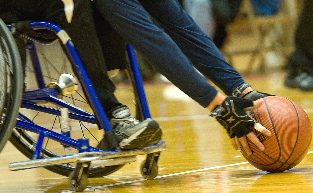 Navy Basketball Player Races Down Court in Wheelchair Basketball Game