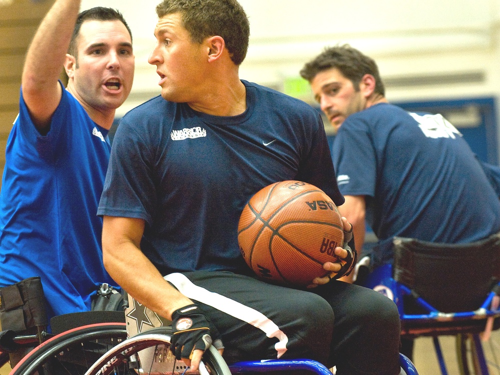 Navy Basketball Player Looks for Open Teammate in Wheelchair Basketball Match