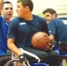 Navy Basketball Player Looks for Open Teammate in Wheelchair Basketball Match