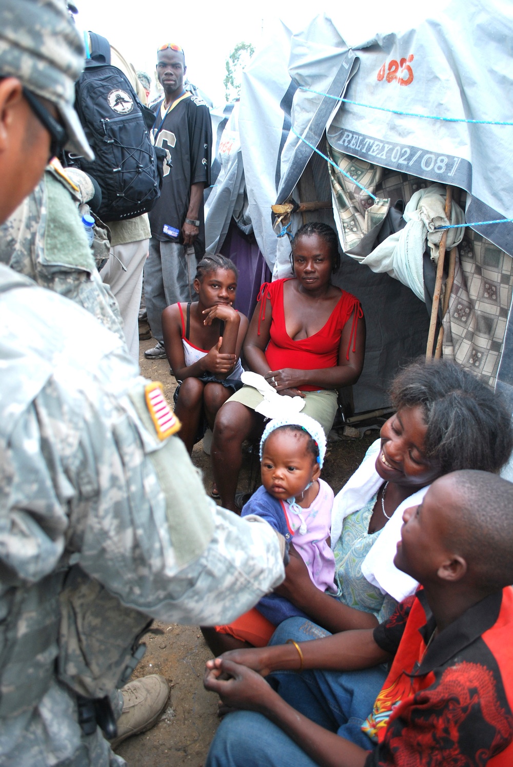 Airborne Soldier Connects with Haitian Child in Tent City