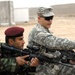 U.S. Soldier Trains Iraqi Counterpart at Combat Outpost in Iraq