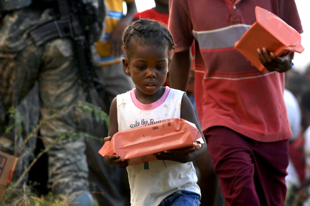 Troops Distribute Humanitarian Meals to Women and Children in Haiti
