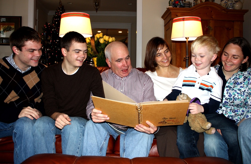Family Gathers for Photo Album Viewing at Home