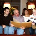 Family Gathers for Photo Album Viewing at Home