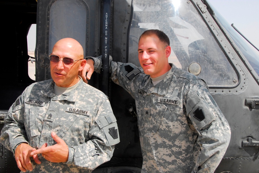 Father and Son Soldiers Pose with Black Hawk Helicopter in Iraq