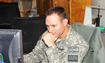 Navy Lt. Reviews Operations Report at Bagram Airfield