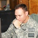 Navy Lt. Reviews Operations Report at Bagram Airfield