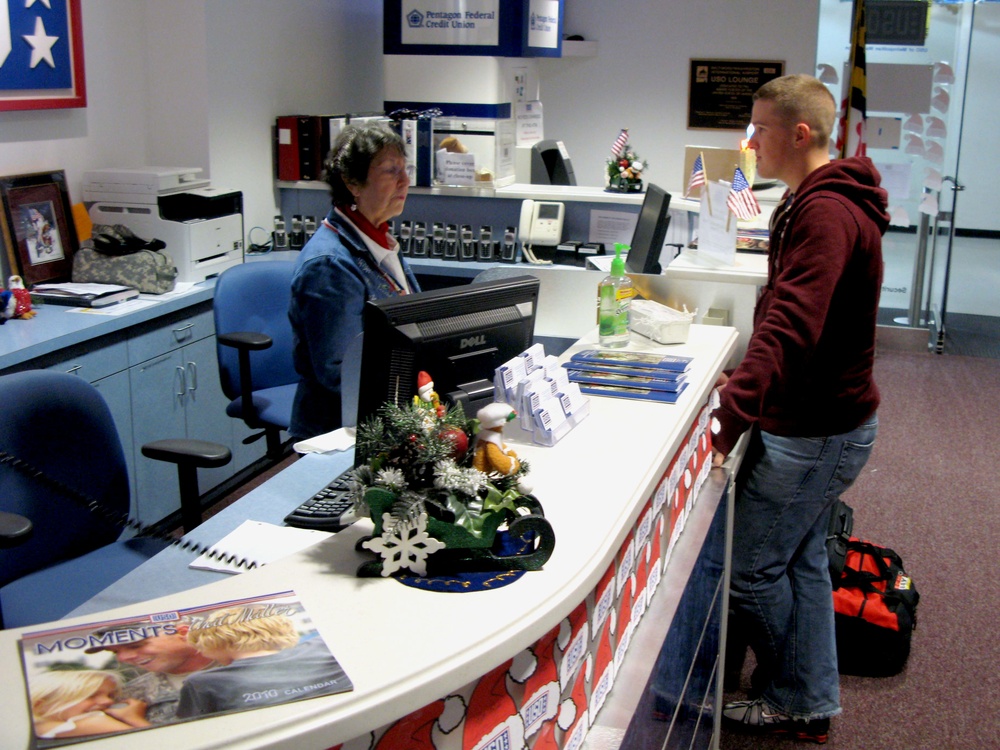 USO Volunteer Welcomes Marine at Airport During Holiday Travel