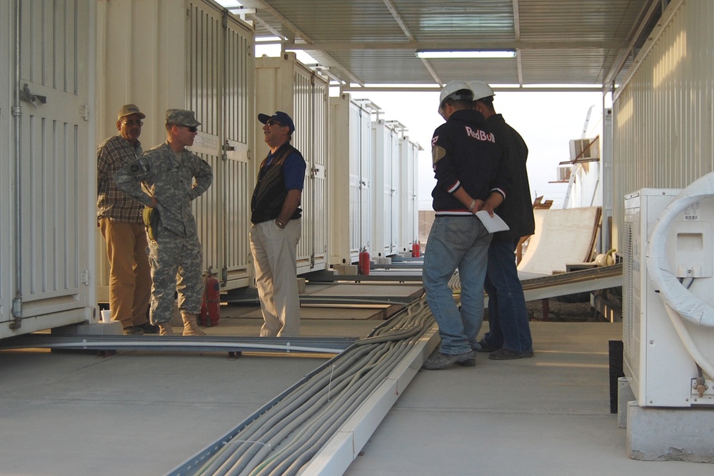 Army Staff Sgt. Laughs with Iraqi Contractor in Basra