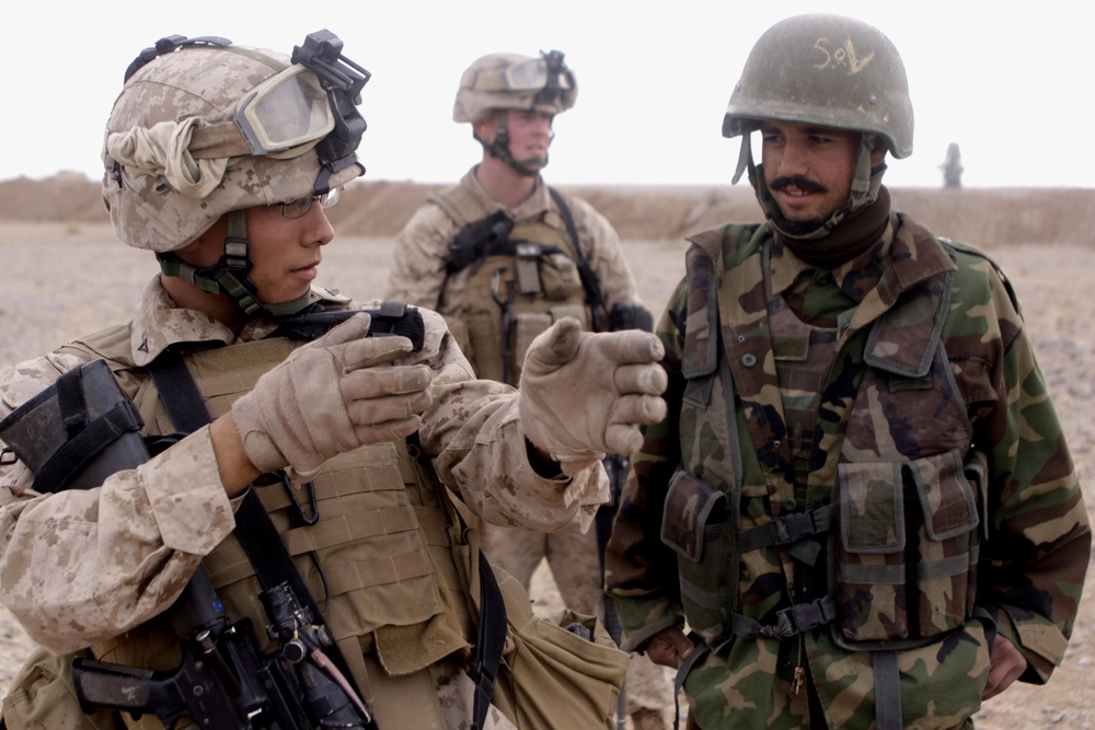 Marine Instructs Afghan Soldier on Firing Stance at Forward Operating Base in Afghanistan