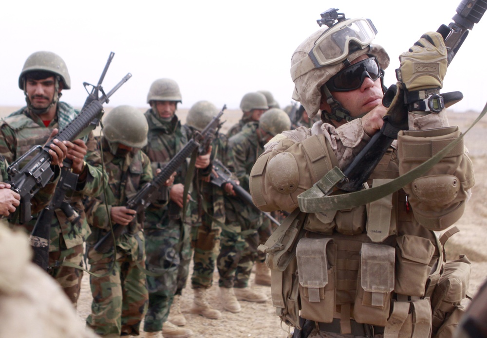Marine Gunnery Sergeant Inspects Afghan Soldier's Rifle