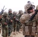Marine Gunnery Sergeant Inspects Afghan Soldier's Rifle