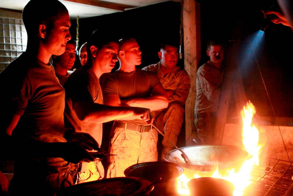 Marine Cooks Chicken by Flashlight at Makeshift Field Kitchen in Afghanistan