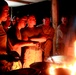 Marine Cooks Chicken by Flashlight at Makeshift Field Kitchen in Afghanistan