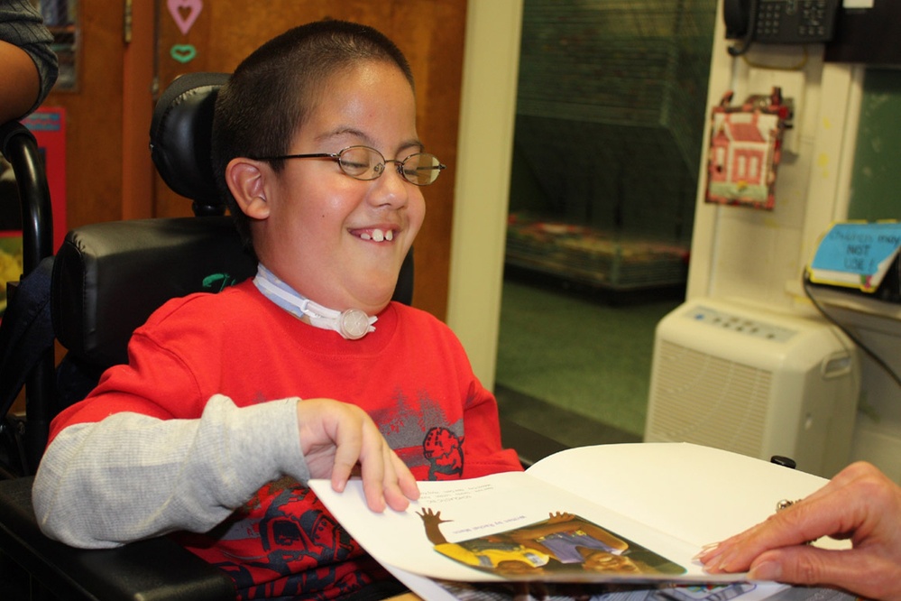 Young Student Reads to Teacher at Marine Base School