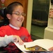 Young Student Reads to Teacher at Marine Base School
