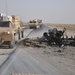 U.S. Military Convoy Bypasses Destroyed Vehicle in Afghanistan