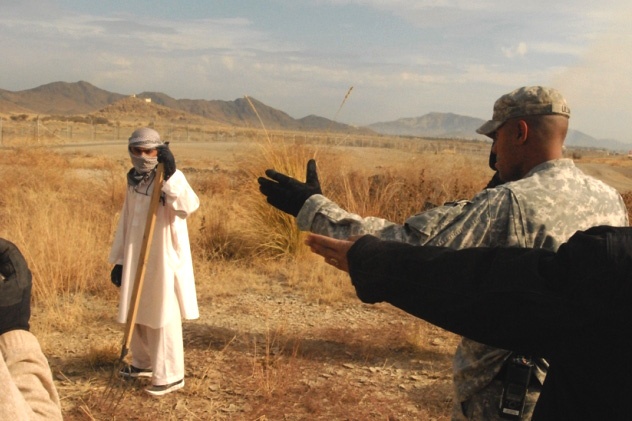 U.S. Soldier Supervises Afghan Worker at Forward Operating Base in Afghanistan