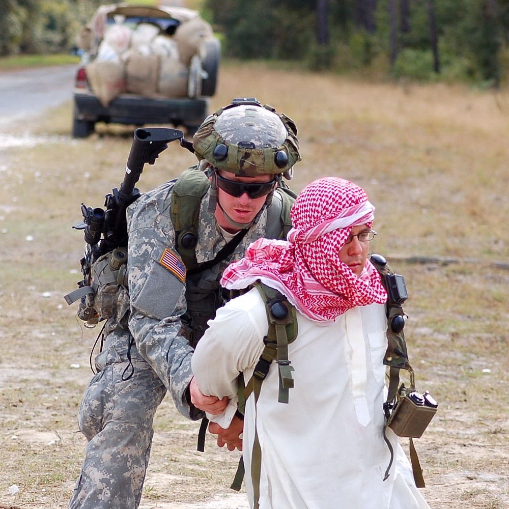 Soldier Secures Insurgent After Finding Bomb in Vehicle During Training Exercise